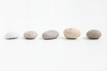 Pebbles in a row on the white ground