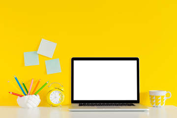 Yellow wall and school accessories and laptop background.