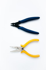 Obraz premium Yellow pliers and blue nippers on the white background 