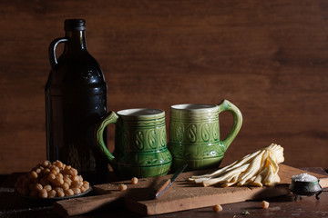 Black wine bottle with snack in black background