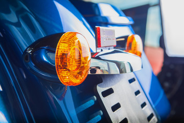 Rear turn indicators orange on a blue motorcycle chopper