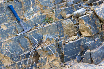 Geological hammer on the rocks