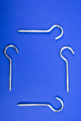 Hook screws on blue background with text space