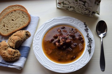 Homemade bean soup , vegetables ,bacon and spices. Detail of bowl of bean soup with large beans