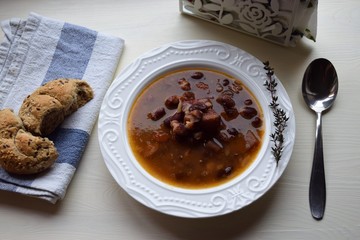 Homemade bean soup , vegetables ,bacon and spices. Detail of bowl of bean soup with large beans