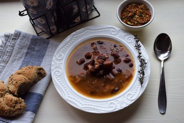 Homemade bean soup , vegetables ,bacon and spices. Detail of bowl of bean soup with large beans