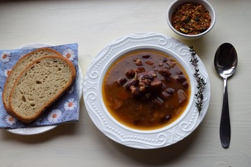 Homemade bean soup , vegetables ,bacon and spices. Detail of bowl of bean soup with large beans