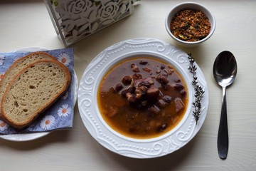 Homemade bean soup , vegetables ,bacon and spices. Detail of bowl of bean soup with large beans