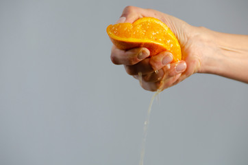 hand squeezing orange