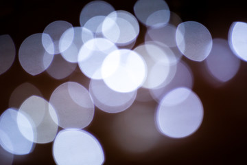 Light blue bokeh on dark background