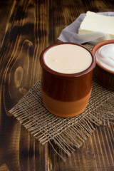 Homemade ryazhenka,sour cream and butter on the rustic  background.Fermented milk products.