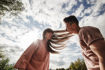 crazy young couple emotionally having fun, kissing and hugging outdoors. Love and tenderness, romance, family, emotions, fun. having fun together