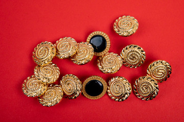 golden buttons in a group on red background