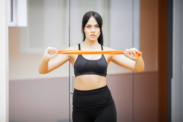 Fototapeta na wymiar Fitness woman. Sports girl in the gym doing exercises