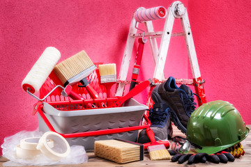 Professional house painter, tools and work equipment. On an antique wooden table. © francescomou