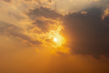 Sunset sunlight through clouds background.