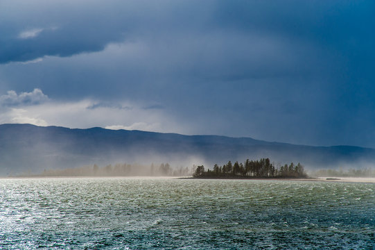 Scenic view of Flathead Lake against cloudy sky