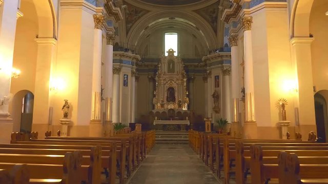 In the Spain inside the ancient church affects the design and richness of decoration and  antique national artifacts - icons, statues of Saints, pictures and art paintings. Shot in motion