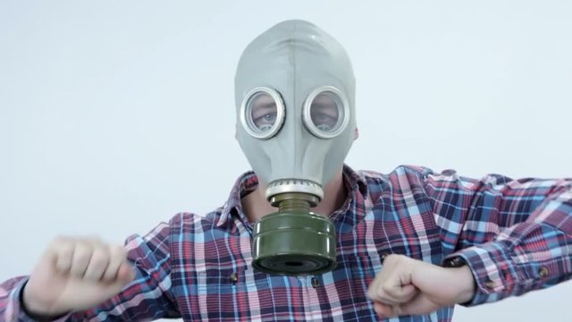 Man dancing a modern dance wears a gas mask