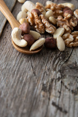 Nuts mix over wooden background. Energy super food. Proteine food. dieting, healthy food. Isolated nuts - almonds, hazelnuts,cashew, brazil nuts.