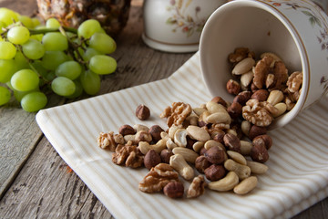 Nuts mix over wooden background. Energy super food. Proteine food. dieting, healthy food. Isolated nuts - almonds, hazelnuts,cashew, brazil nuts.