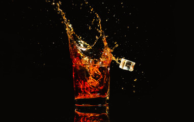whiskey with splash on black background