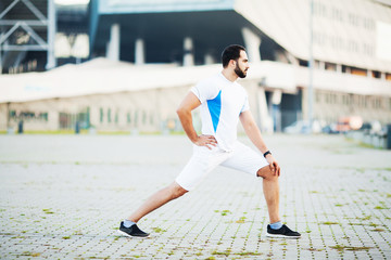 Fitness. Sportsman doing stretching exercises in park