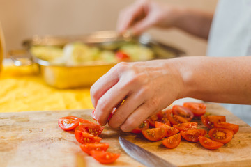 Chopping cherry tomatoes on a cutting board