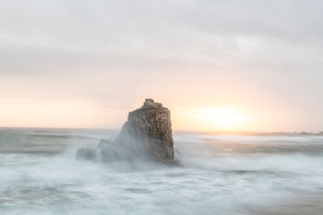 View of rock formation in sea during sunset