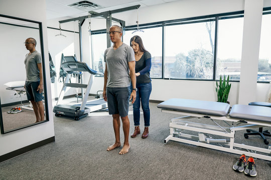 Physiotherapist examining patient in clinic