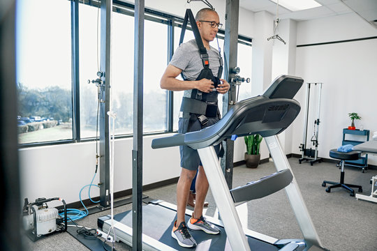 Man standing on treadmill in clinic