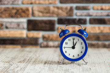 Vintage background with retro alarm clock on table