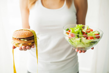 Diet and Healthy eating. Young woman eating healthy salad after workout