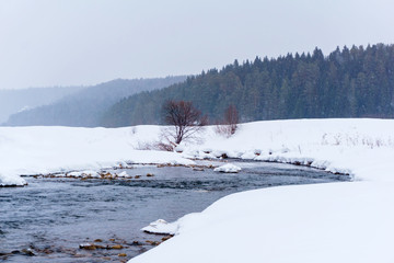 early spring, snowfall, stream cleared of ice