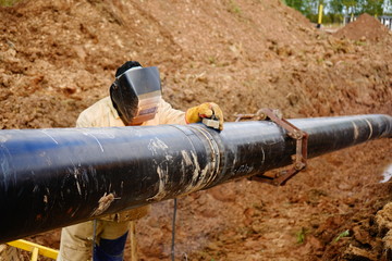 electric welder welds a pipe	