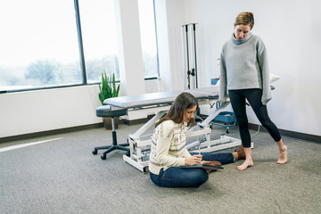 Physiotherapist using digital tablet in clinic