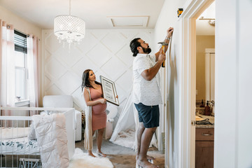 Couple decorating nursery
