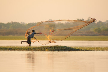 NAKHON PHANOM, THAILAND - Nov 4, 2018 : Fisherman casting a net into the lake