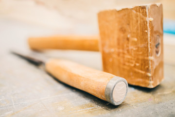 Carpentry workshop - a professional tool in the workplace- wooden mallet and chisel