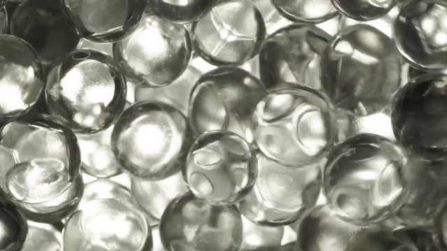 Colorless hydrogel balls closeup, movement