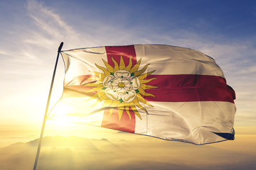 North Yorkshire West Riding county flag waving on the top sunrise mist fog