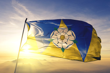 West Yorkshire county of England flag waving on the top sunrise mist fog