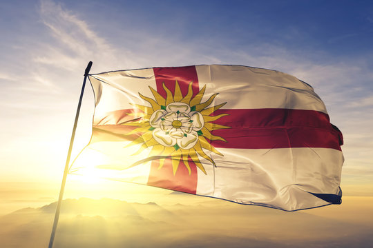 North Yorkshire West Riding county flag waving on the top sunrise mist fog