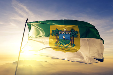 Rio Grande do Norte state of Brazil flag waving on the top sunrise mist fog