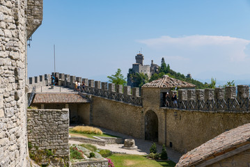 Fototapeta na wymiar Tourists visit the fortress known as Guaita or Rocca in San Marino