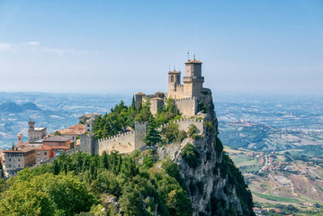 Guaita tower in the fortifications of San Marino on Monte Titano, with the City of San Marino on the left.