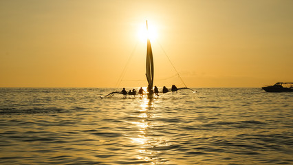 Sailboat With Sitting Tourists on Golden Sunset Sea - Boracay Island, Panay - Philippines
