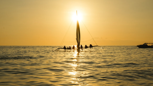 Sailboat With Sitting Tourists on Golden Sunset Sea - Boracay Island, Panay - Philippines