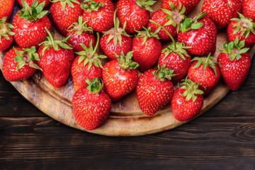 Strawberries on a plate on a wooden table