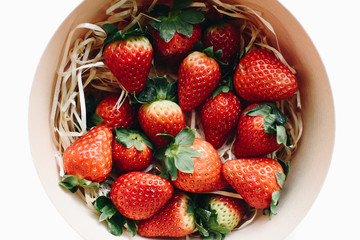 Delicious fresh strawberries in a round wooden box, top view
